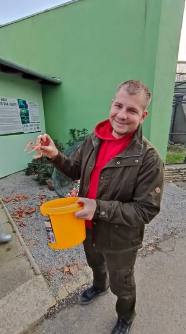 Keeper holding food for animals